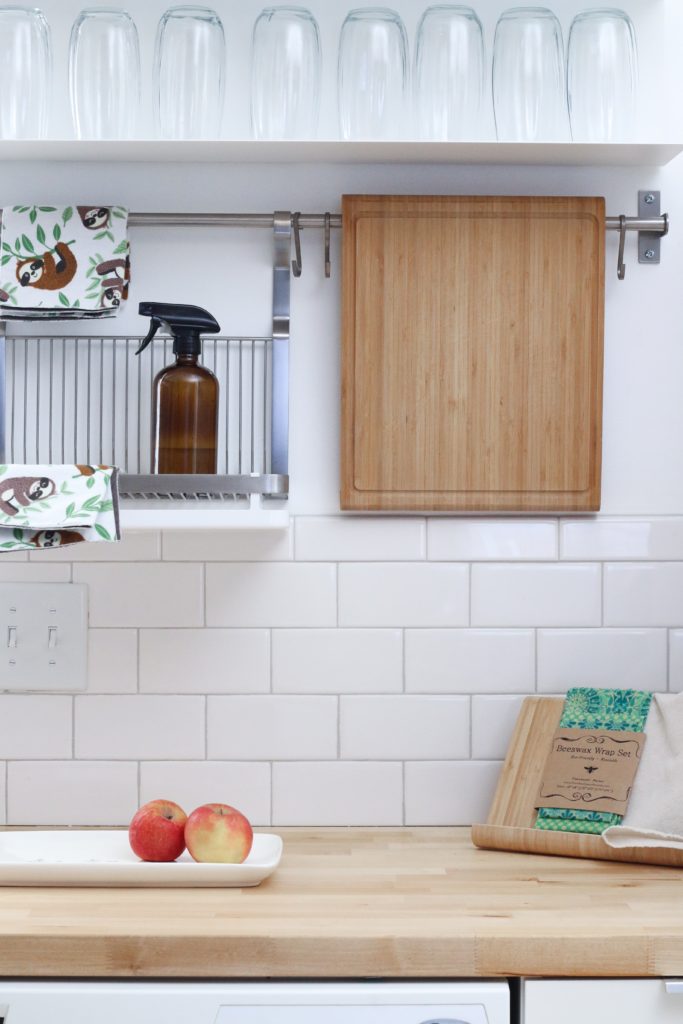 clean kitchen with amber cleaning bottle and cutting board