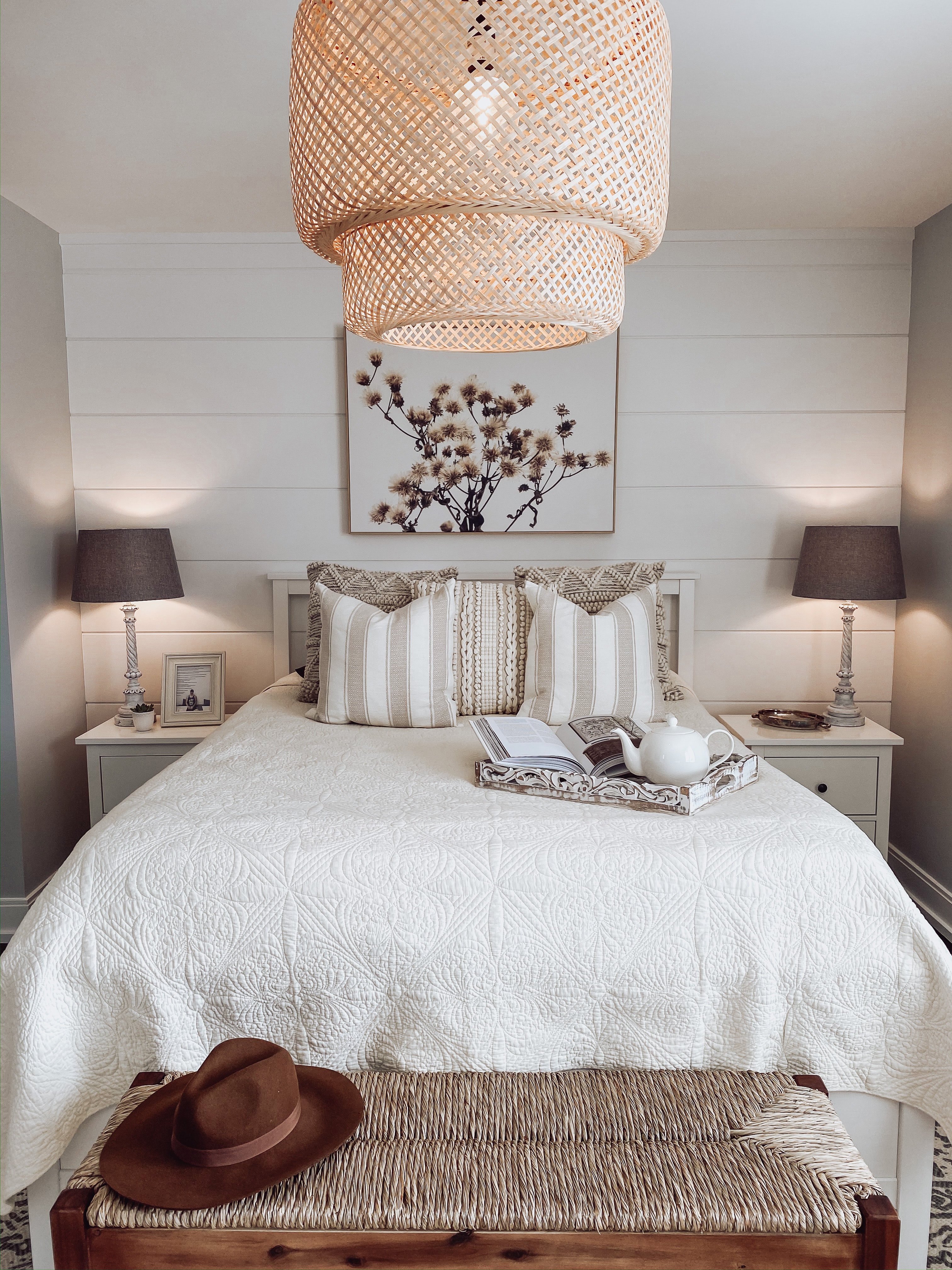 aesthetic bedroom with white quilted duvet and a shiplap wall, minimal decor