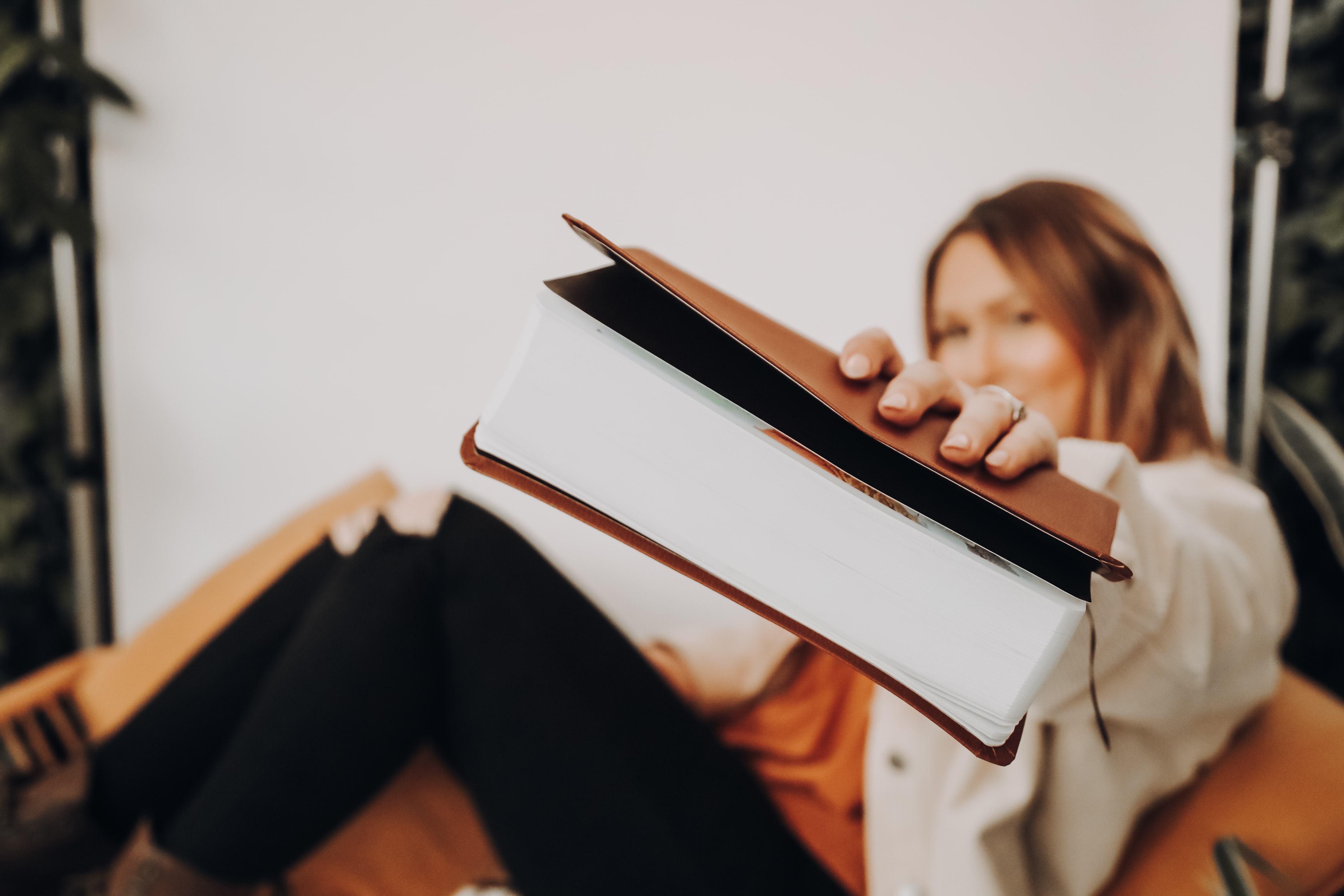 Unfocused image of woman smiling while holding out her bible