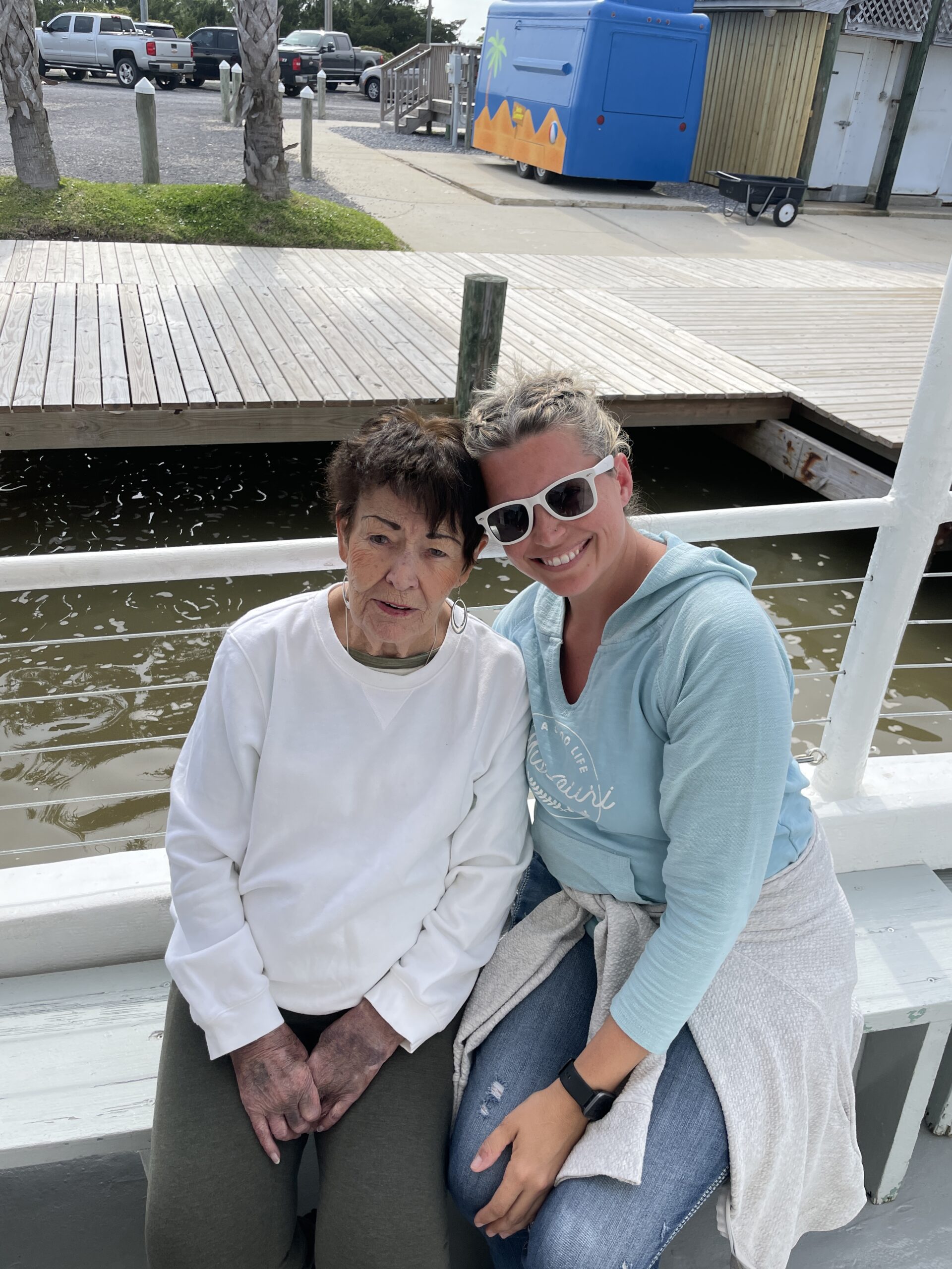 grandma with young woman on a docked boat