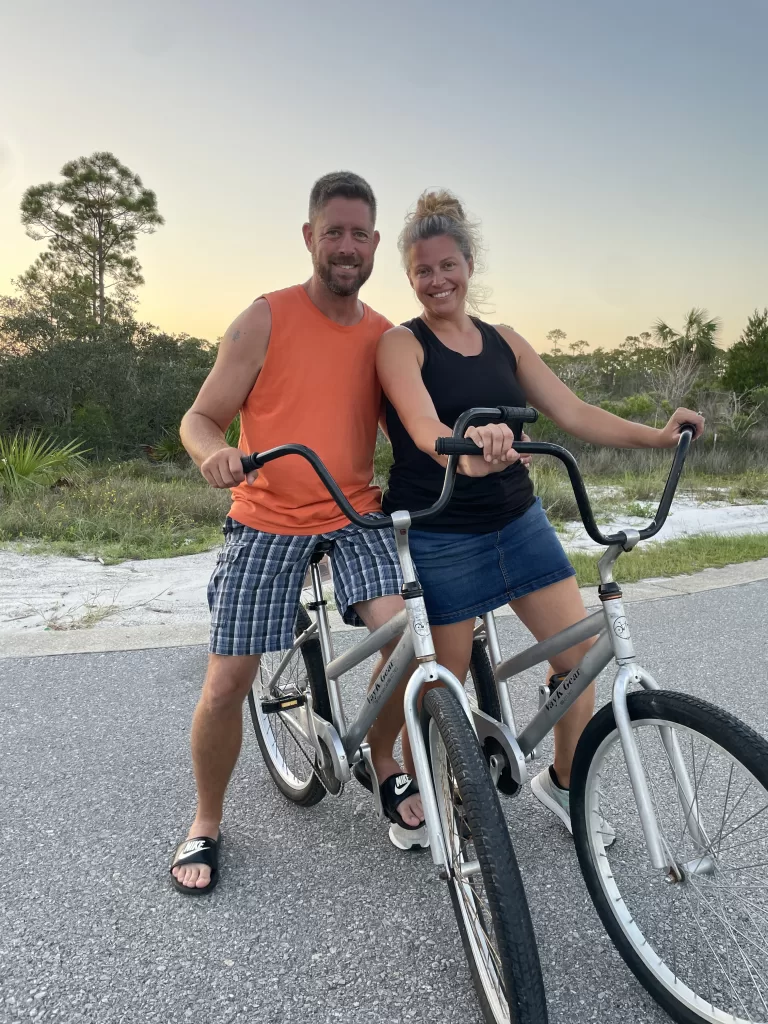 man and wife on a beach bike ride together