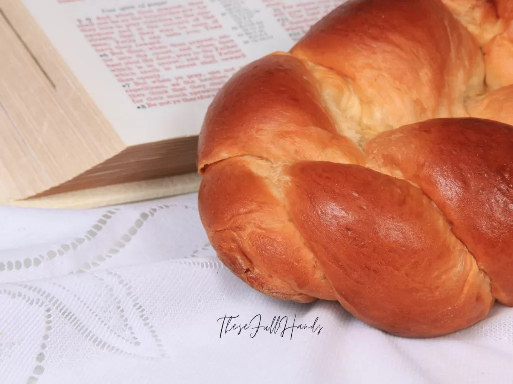 challah bread and bible on a lace tablecloth