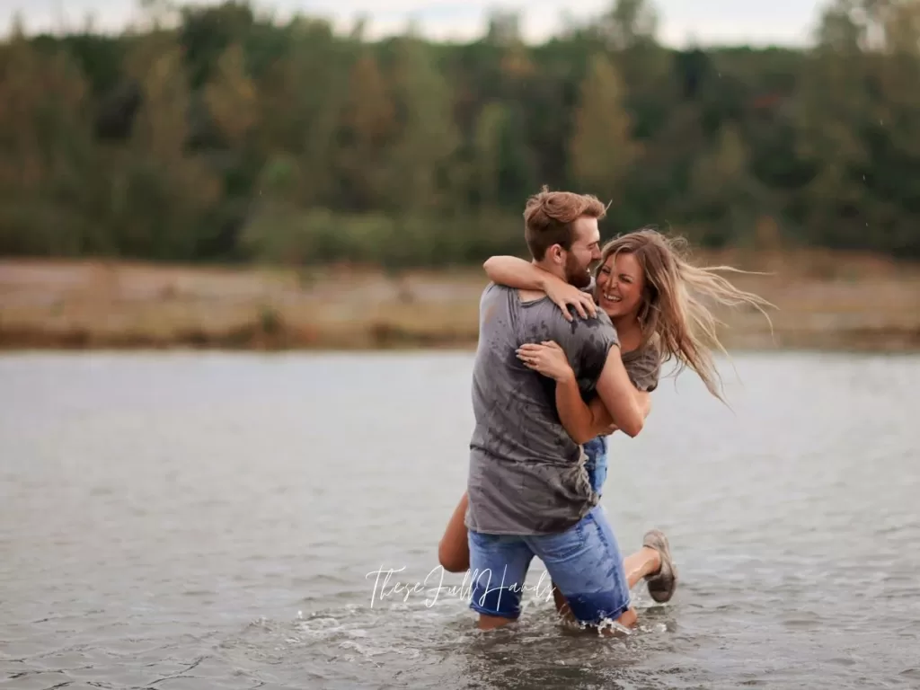 man and woman laughing together in the water