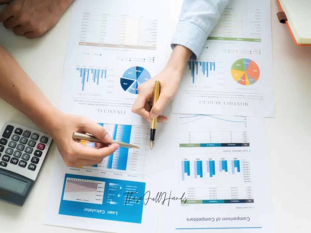 colorful budget sheets being reviewed by man and woman