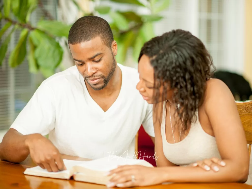 husband and wife model a healthy marriage by reading the Bible together