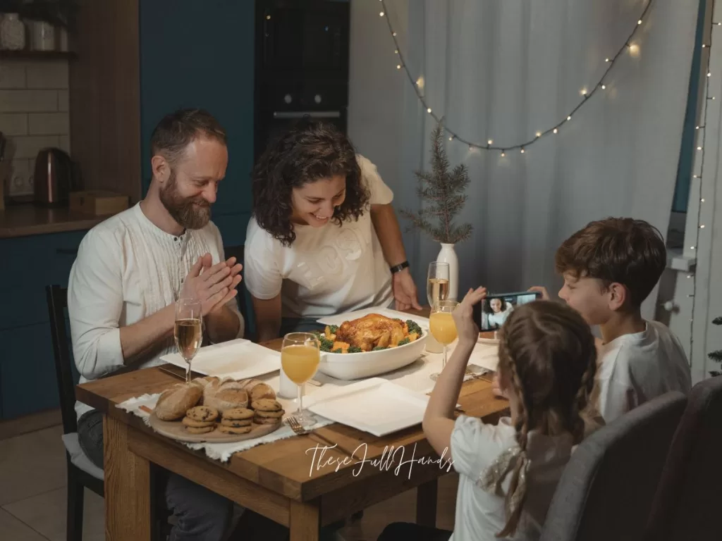 family of four sitting down to dinner together