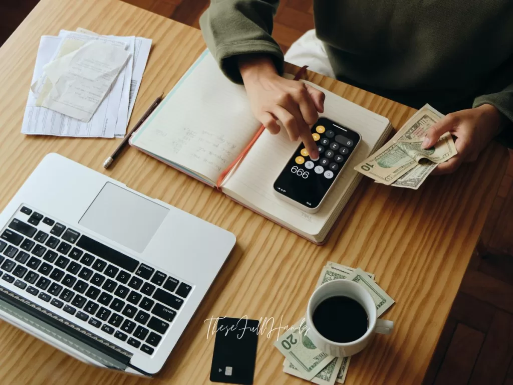 woman managing money and her cash with a computer calculator and paper