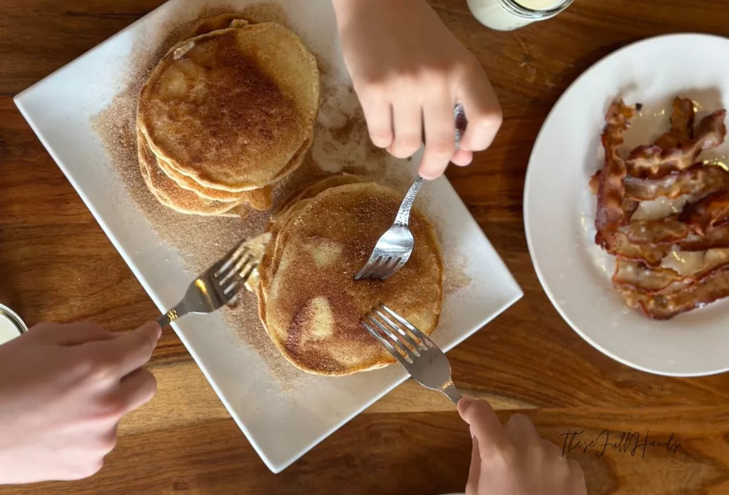 forks going in for the stack of snickerdoodle sourdough discard pancakes