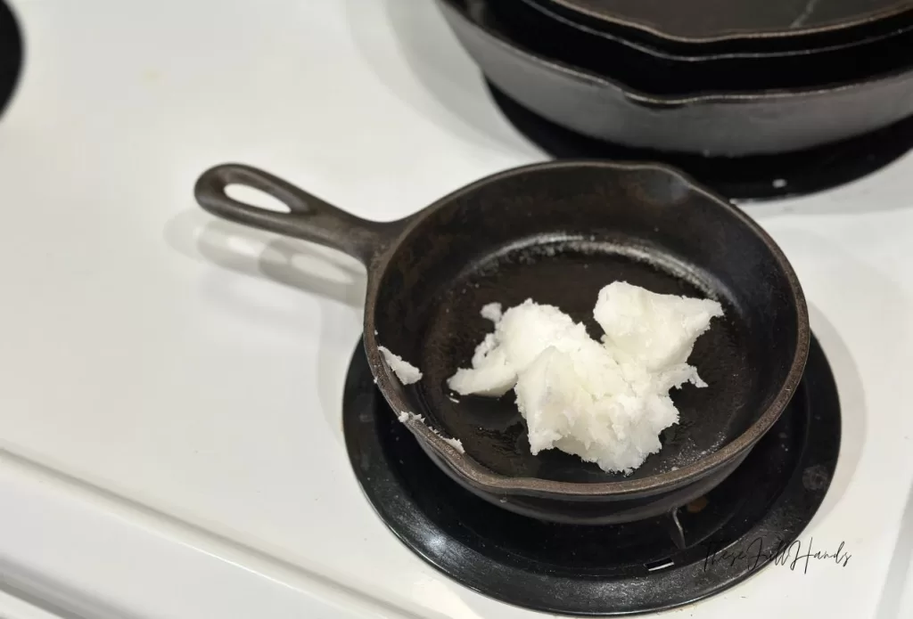 melting coconut oil in a small cast iron skillet on the stove.