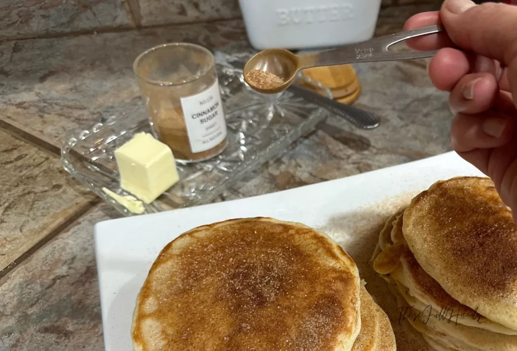 cinnamon sugar sprinkled on top of sourdough discard pancakes makes these taste like a snickerdoodle cookie