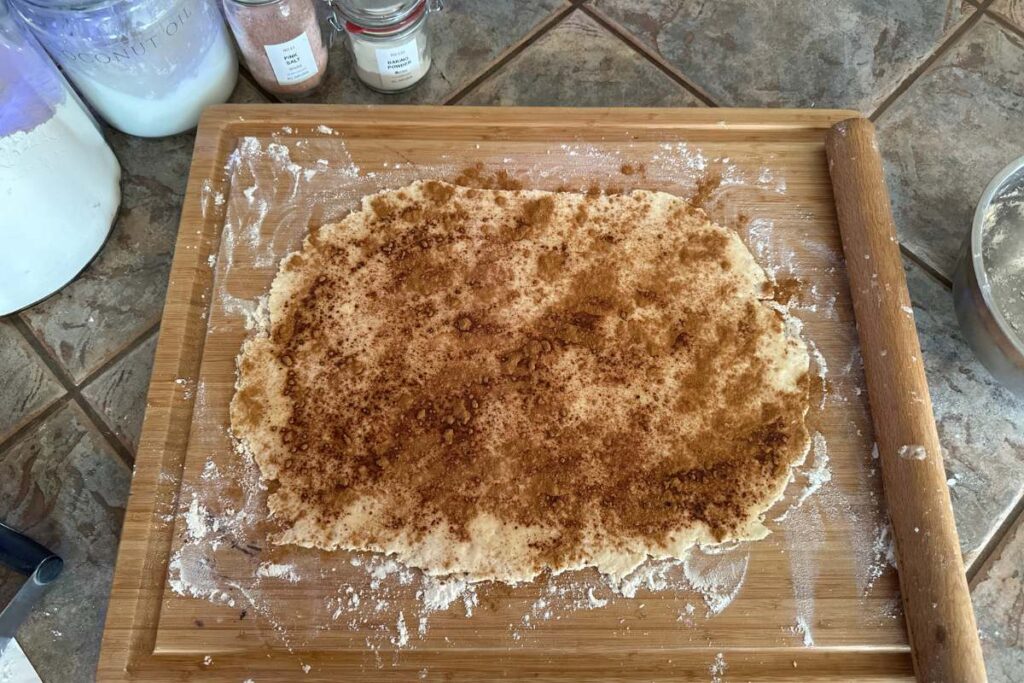 cinnamon sprinkled evenly over rolled out dough