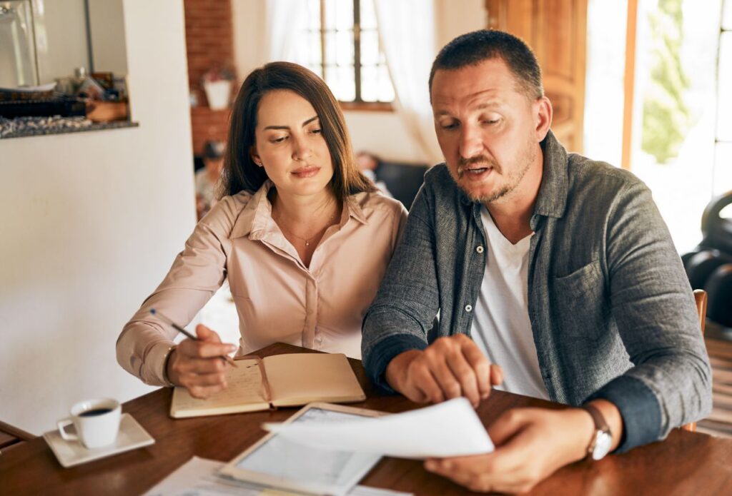 homemaker and husband planning or working together on the calendar and budget, being your own boss as a homemaker makes it a rewarding career
