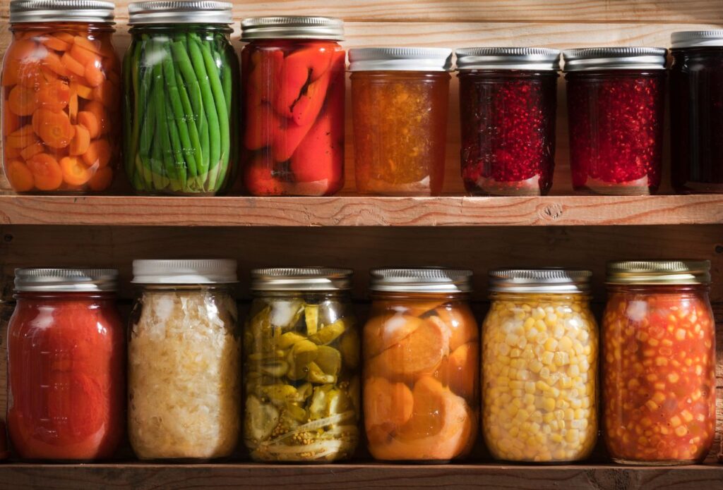 glass canning jars filled with colorful preserved foods