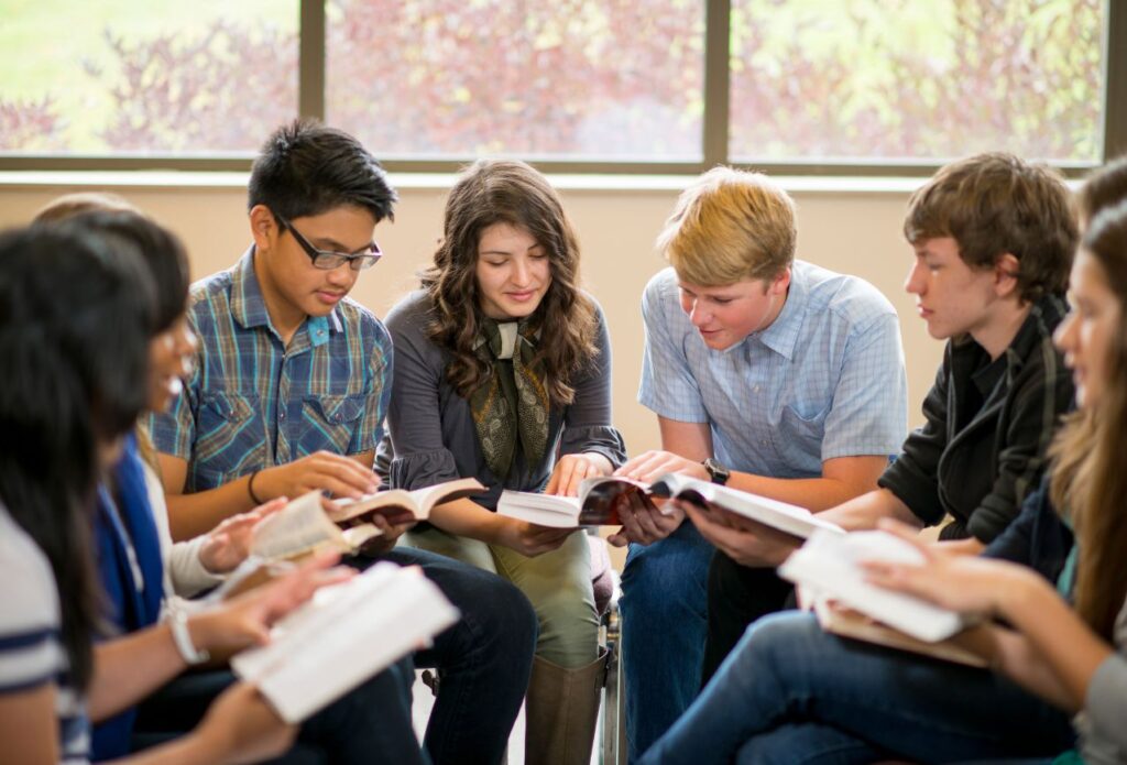 teen peers in a group studying the Bible