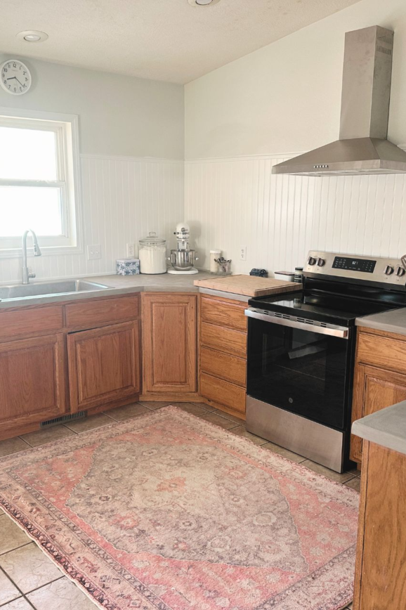 kitchen with concrete countertops and headboard backsplash