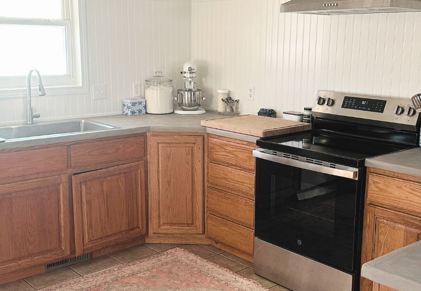 kitchen with concrete countertops and headboard backsplash